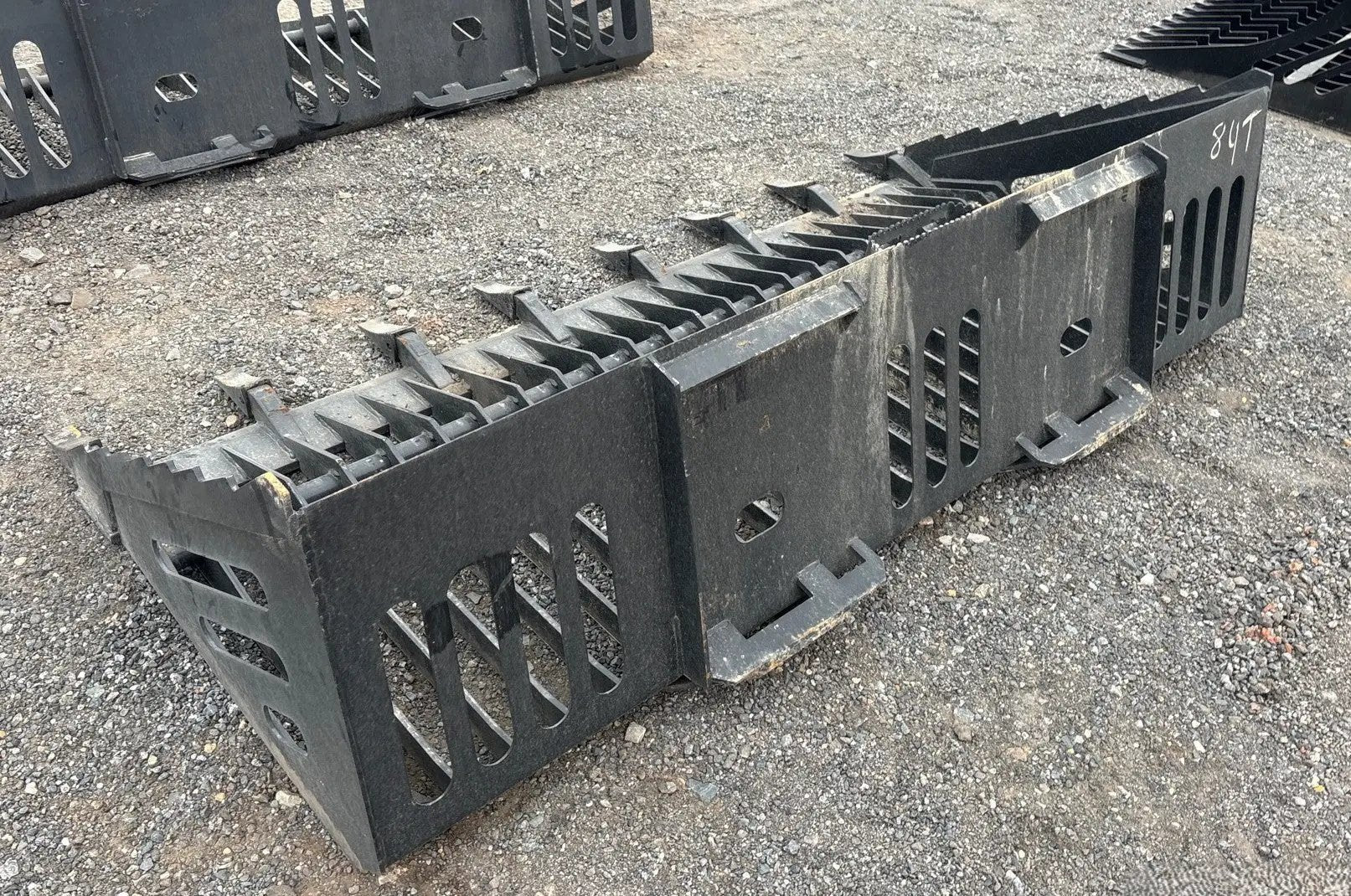 Wildcat 84-Inch Rock Skeleton Bucket with Teeth for Skid Steer; black steel attachment, two units visible.