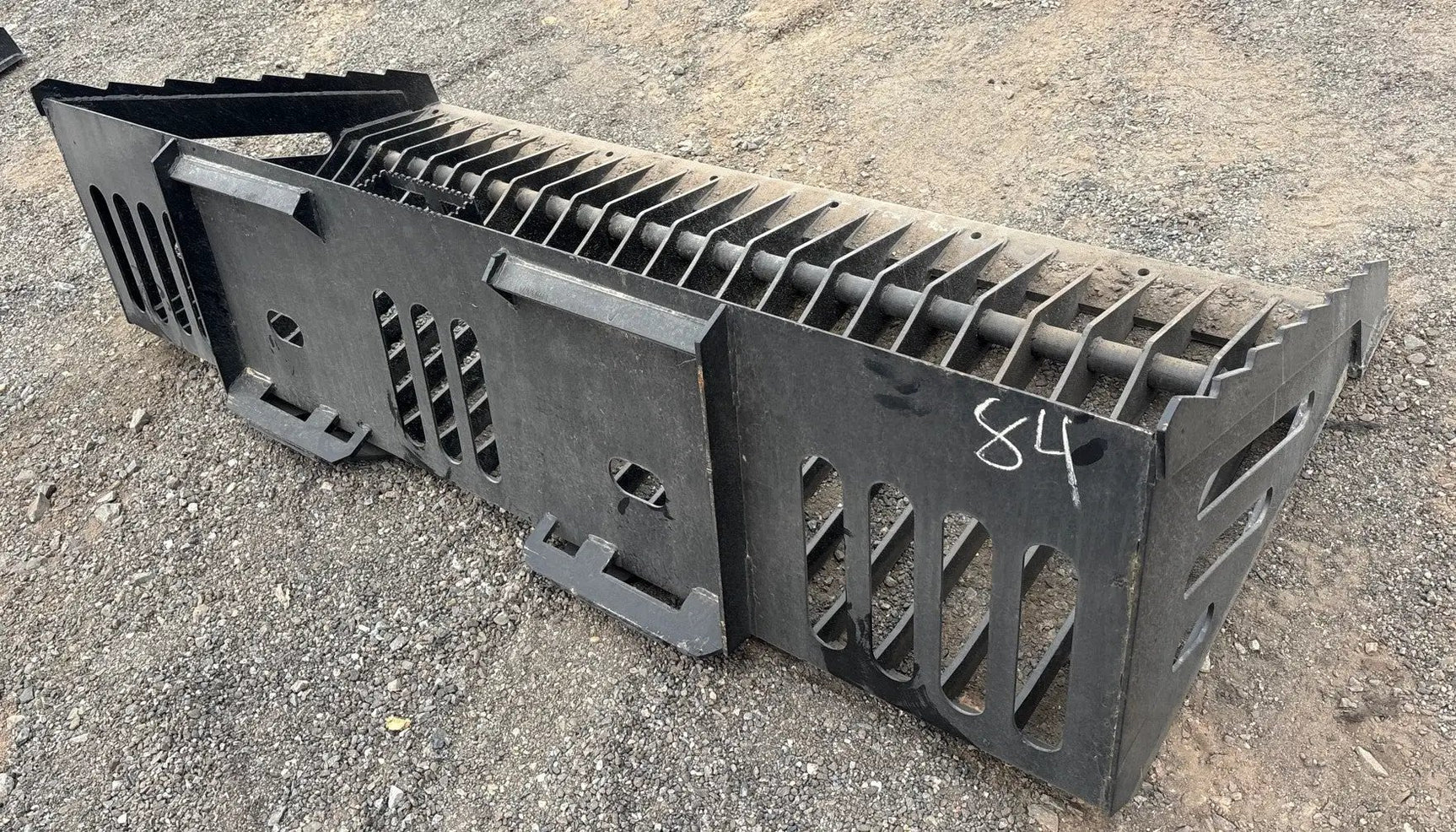 Wildcat 84-inch heavy-duty skeleton rock bucket for skid steer, black steel with ribbed sides.