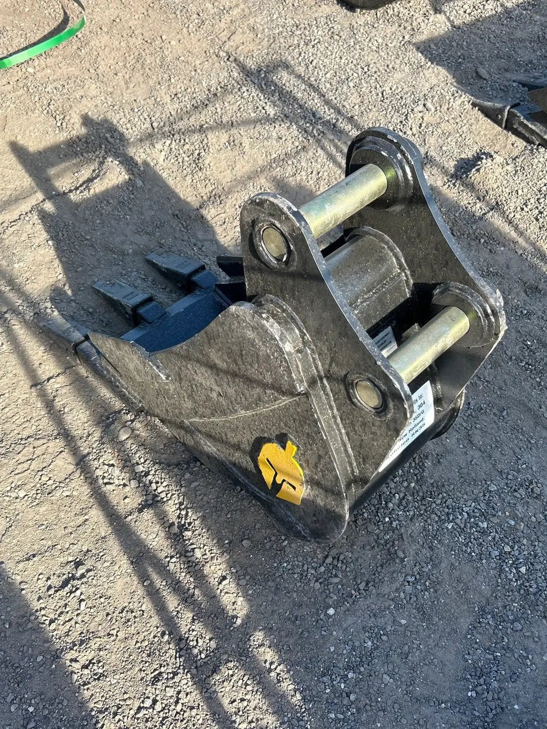 Excavator trenching bucket 12-inch Trojan attachment for Cat 303-304; black steel with yellow logo