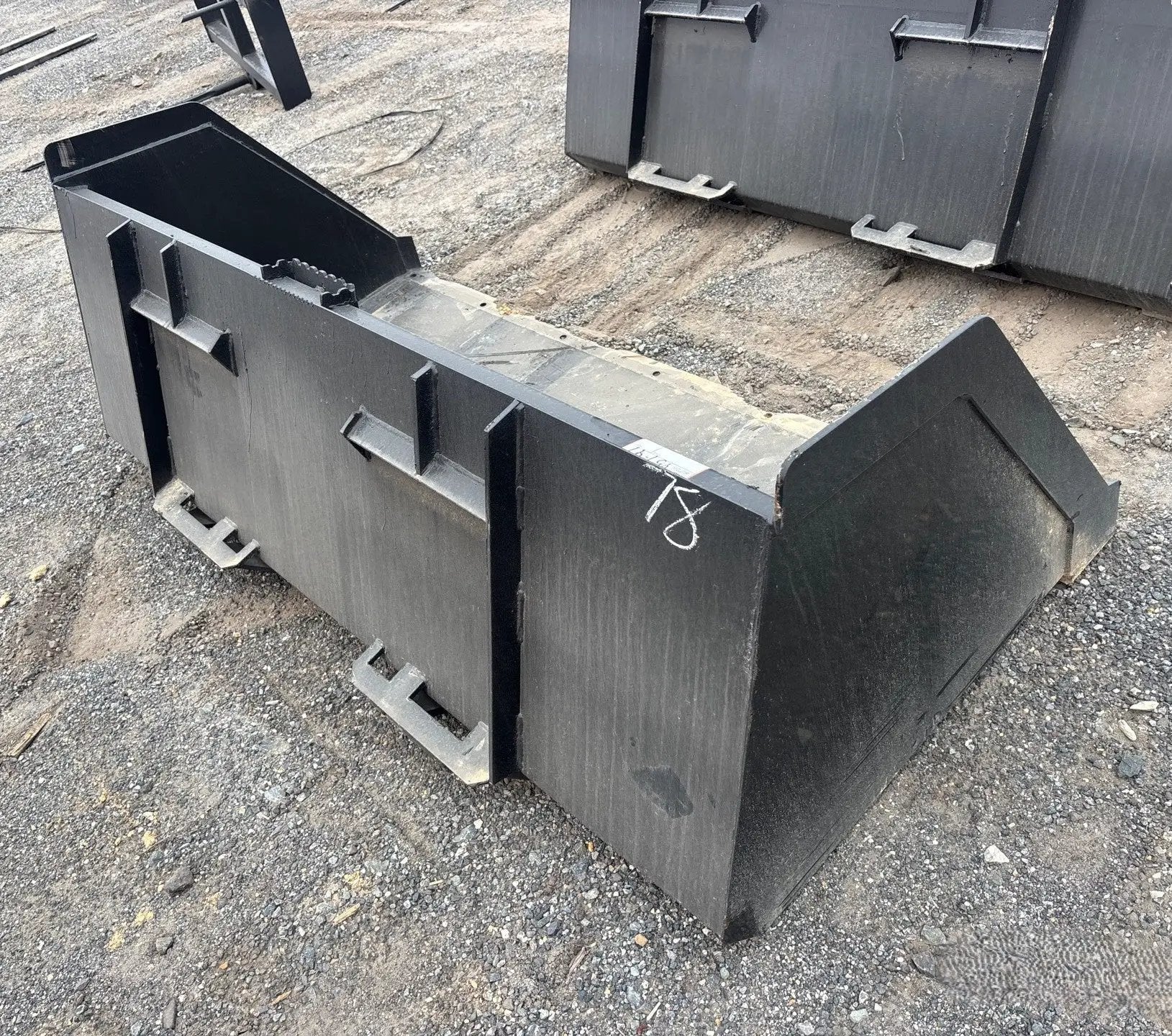 Black 78-inch snow bucket for skid steer with universal attachment by Wildcat