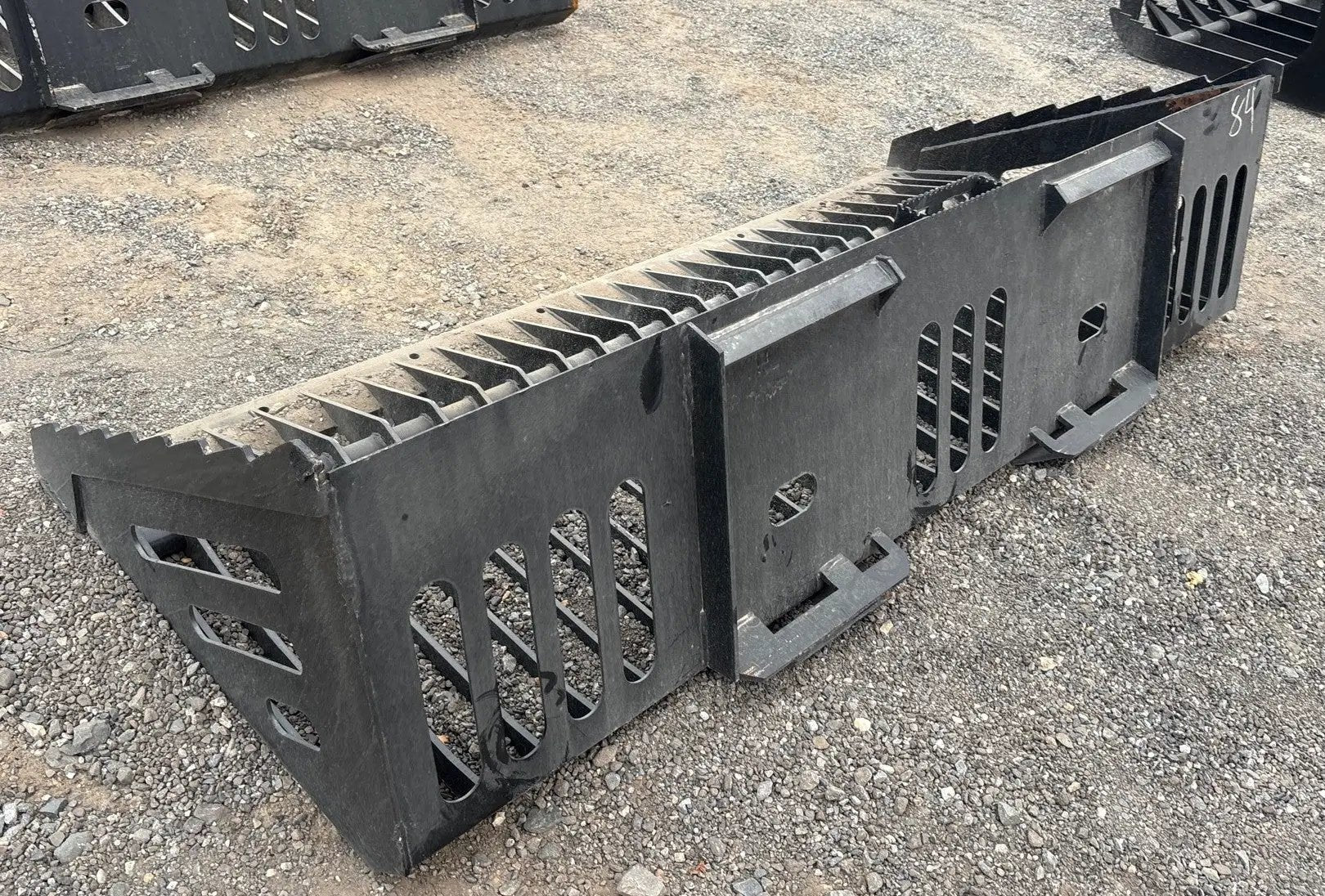 Wildcat 84 Inch heavy-duty skeleton rock bucket for skid steer; black steel with slotted side panels.
