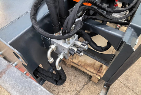 72-Inch hydraulic snow blower attachment for skid steer by Handy, gray metal with braided hoses